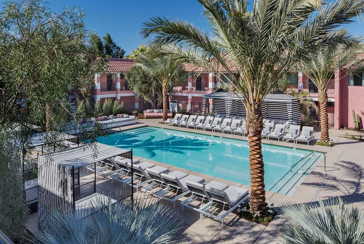 Overhead view of the pool at the Sands Hotel & Spa, striped cabanas and date palms